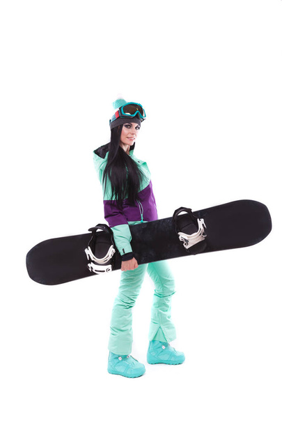 woman in purple ski costume with snowboard - Photo, Image
