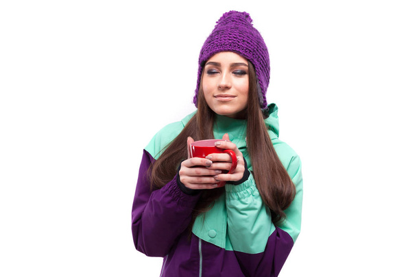 woman in ski coat holds cup - Photo, Image