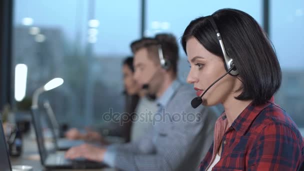 Call center operators at work - Materiał filmowy, wideo