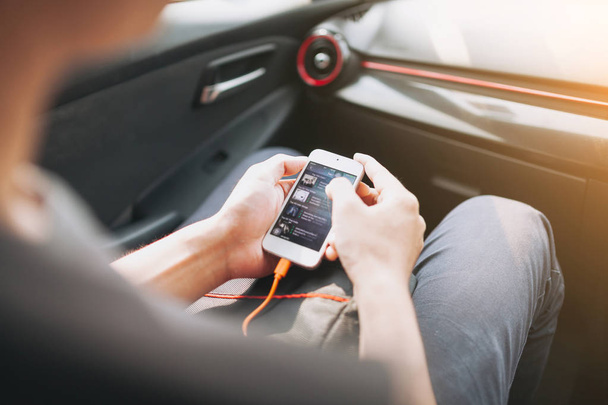 Man connecting phone to the car media system - Foto, imagen