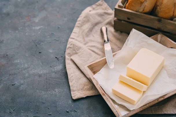 Butter over rustic background with copy space - 写真・画像