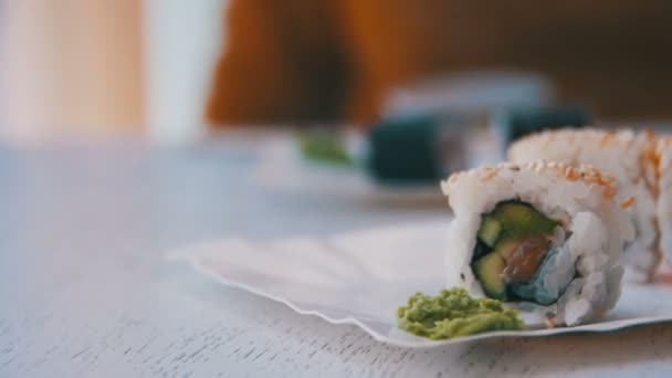 Fresh Sushi Rolls in a Japanese Restaurant on a Stylish White Wooden Table - Filmagem, Vídeo
