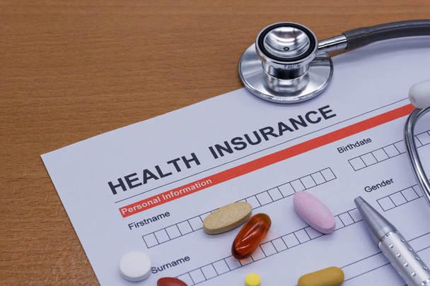Health insurance paperwork, medicine, stethoscope. Health insura - Photo, Image