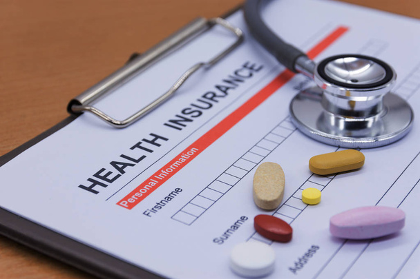 Health insurance paperwork, medicine, stethoscope. Health insura - Photo, Image