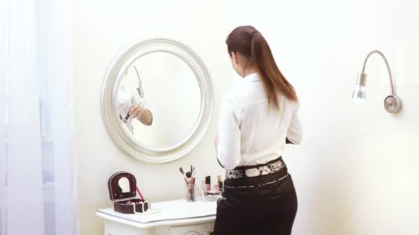 Girl paints face at mirror - Felvétel, videó