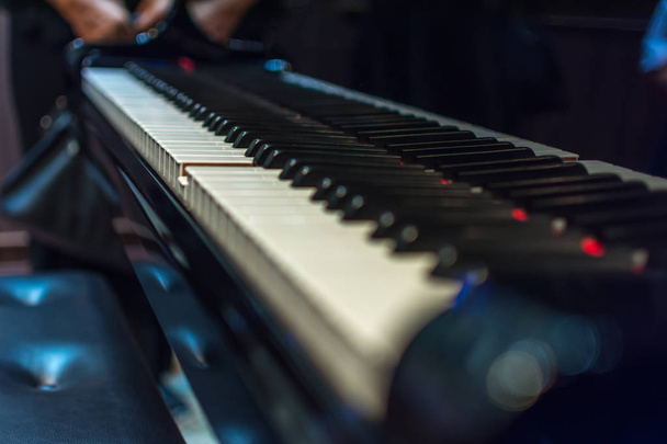 Piano keys on black classical grand piano - Foto, Imagen