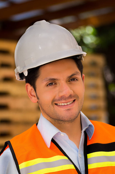 Handsome young engineer portrait at construction site - Foto, Imagen