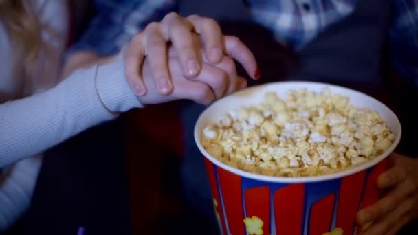Popcorn gros plan recadré d'une femme souriante heureuse saisissant pop-corn de son ami
 - Séquence, vidéo