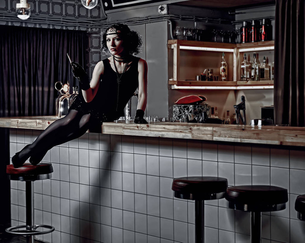 girl with a cigarette at the bar counter - Photo, Image