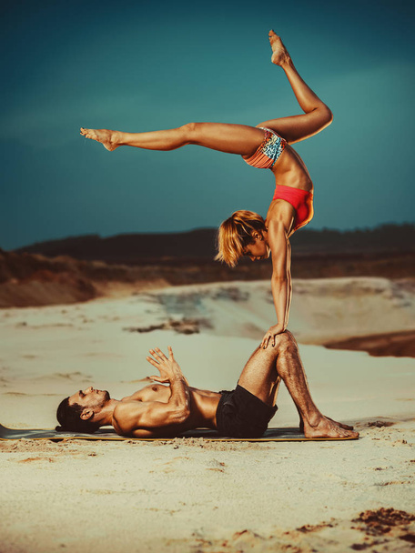 Sports couple doing acroyoga exercises - Φωτογραφία, εικόνα