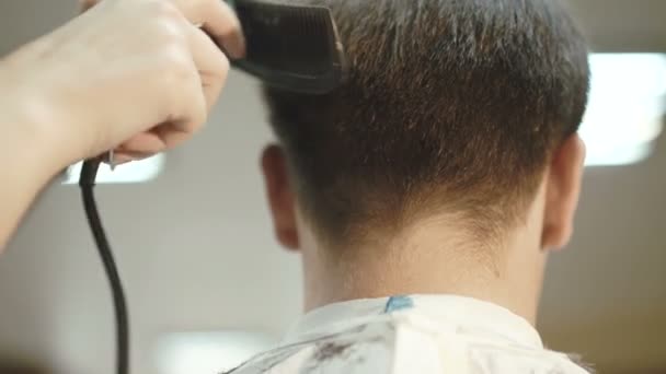 Close up of handsome man gets a haircut in the salon 4K - Felvétel, videó