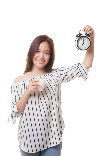 Healthy Asian woman drinking  glass of milk hold clock. - Foto, immagini