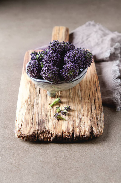 Fresh purple broccoli. Vegan food. Dark background. - Fotoğraf, Görsel