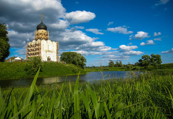 White church with blue domes and scenic clouds, Bogolubovo, Russia - 写真・画像