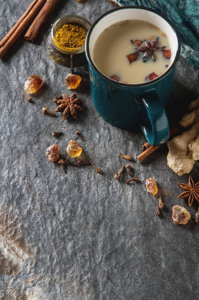 Traditional Indian masala tea in ceramic cup with spices to milk - 写真・画像