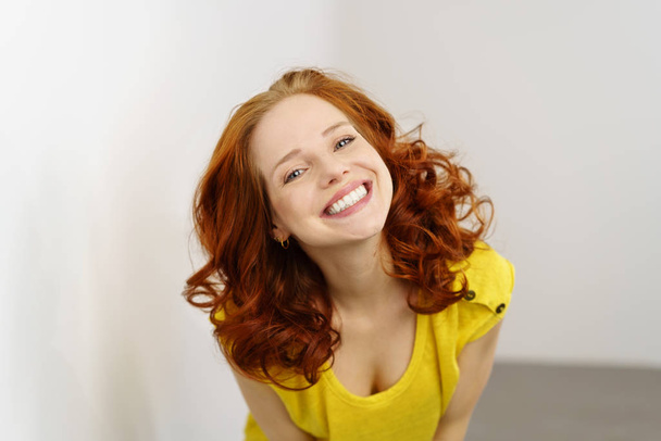 Friendly extrovert young redhead woman - Фото, изображение