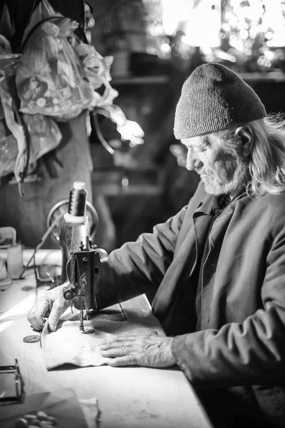 Old man sewing bw - Photo, Image