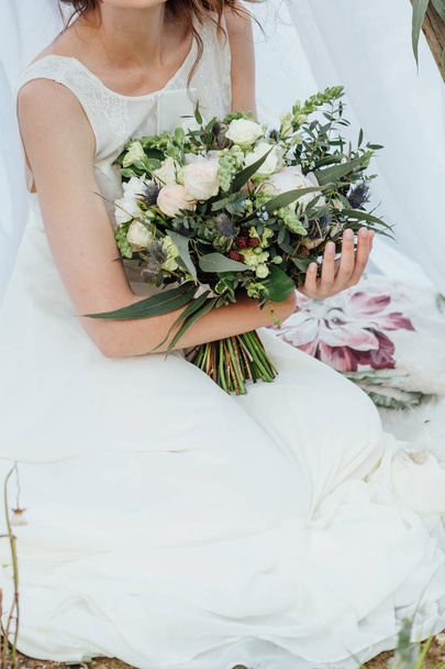 Wedding bouquet in bride's hands. - Φωτογραφία, εικόνα