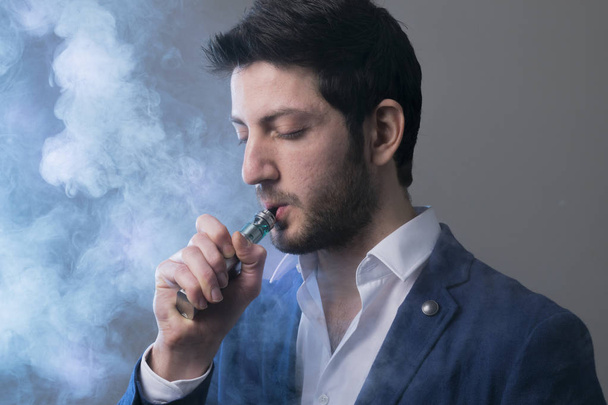 man vape an electronic cigarette with lots of smoke.  - Photo, Image