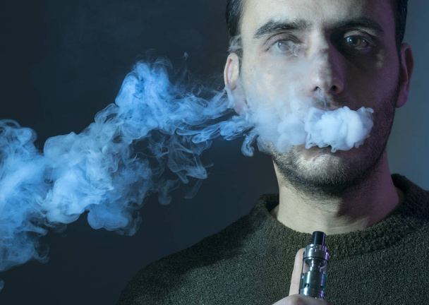 man vape an electronic cigarette with lots of smoke.  - Photo, Image