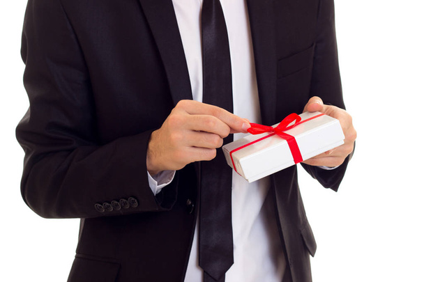 Young man in suit holding a present - Photo, Image
