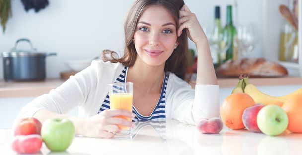 Portrait of a pretty woman holding glass with tasty juice - Фото, изображение