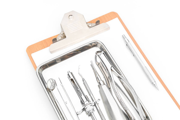 Dental tools, equipment and dental chart on white background. - Φωτογραφία, εικόνα