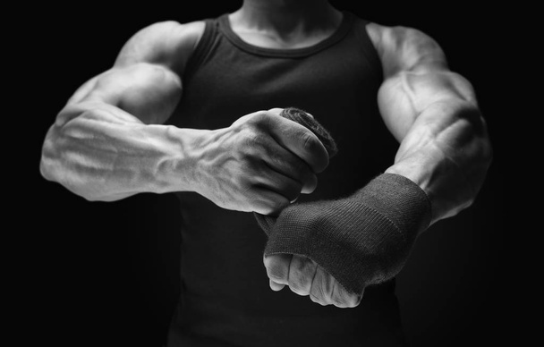 Close-up photo of strong man wrap hands on black background Man  - Photo, Image