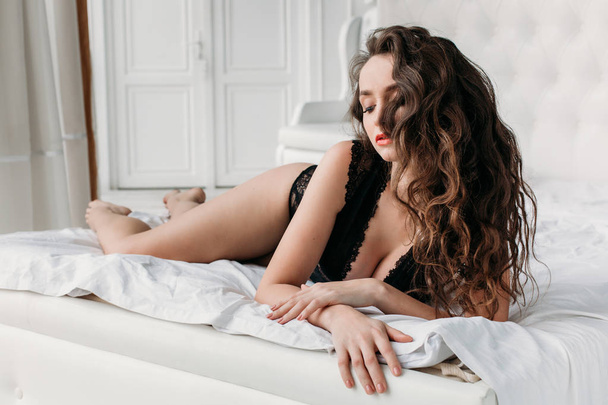 Sexy brunette in bed in underwear - Valokuva, kuva