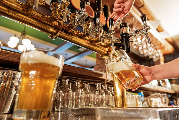 Male arm pouring beer in tap-room - Photo, image