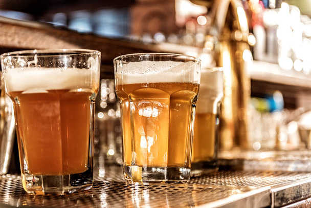 Glass of cold alcohol drink in pub - Foto, Bild
