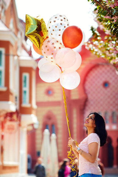 beautiful young woman with air balloons on the city street - Photo, Image