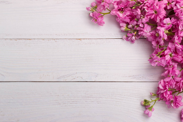 Pink flowers on wooden background - Photo, Image