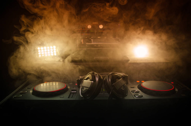 DJ Spinning, miksaus, ja raapiminen yökerhossa, Kädet dj säädellä eri radan ohjaimet dj: n kannella, strobe valot ja sumu, valikoiva keskittyä, lähikuva. Dj Music Club elämän käsite
 - Valokuva, kuva