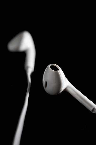 Ear headphone on black background - Foto, Imagen