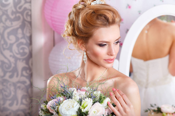 Beautiful bride with fashion wedding hairstyle and bouquet. Closeup portrait of young gorgeous bride. Wedding. Studio shot - 写真・画像