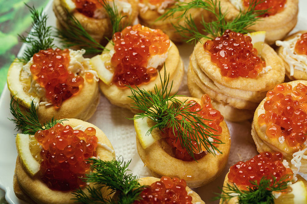 Tartlet with red caviar,Tartlet with red caviar close up. Snacks with red caviar, gourmet food, appetizer,The tartlets filling of mascarpone - Photo, Image