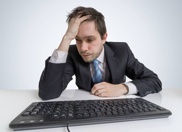 Overworked and exhausted businessman is working with computer. - Photo, Image