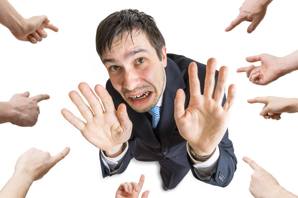 Many hands are pointing and blame stressed man. Isolated on whit - Photo, Image