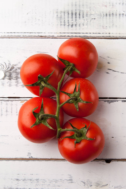 Fresh organic tomatoes on white wooden table, top view. - Fotó, kép