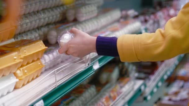 Woman chooses eggs in the supermarket - Záběry, video