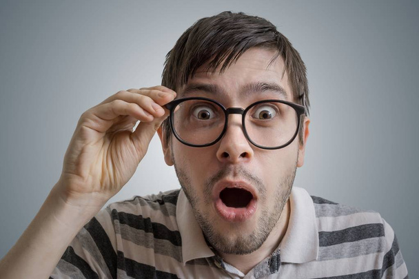 Nerdy man has open mouth and is surprised and shocked. - Photo, Image