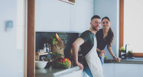 Beautiful young couple is having fun in kitchen at home - Foto, immagini