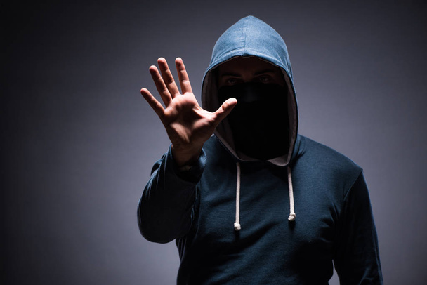 Man wearing hood in dark room - Фото, зображення
