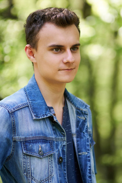 Teenage boy standing in forest  - Fotó, kép