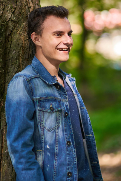 Teenage boy standing in forest  - Fotoğraf, Görsel