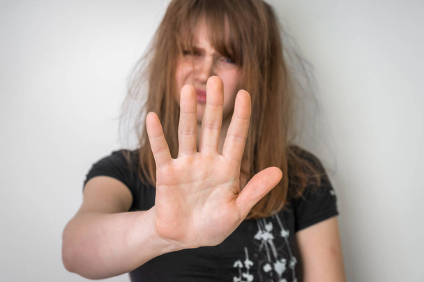 Woman is showing stop gesture with her hand - Photo, Image