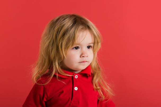 small baby boy with long blonde hair in red shirt - Foto, Bild