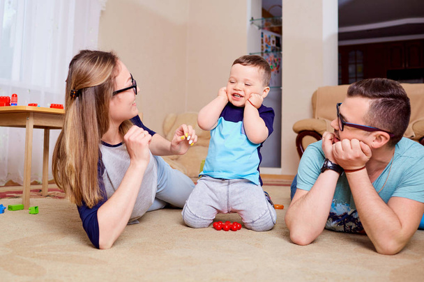 Happy family having fun playing on the floor in room - Фото, изображение