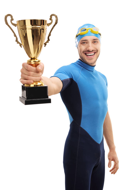 Happy swimmer showing a gold trophy - Фото, зображення